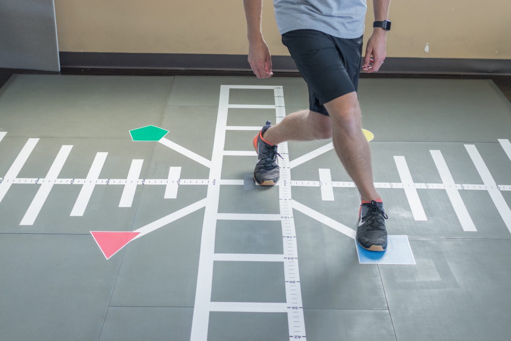Patient doing rehab exercises on smartcells physical therapy mat