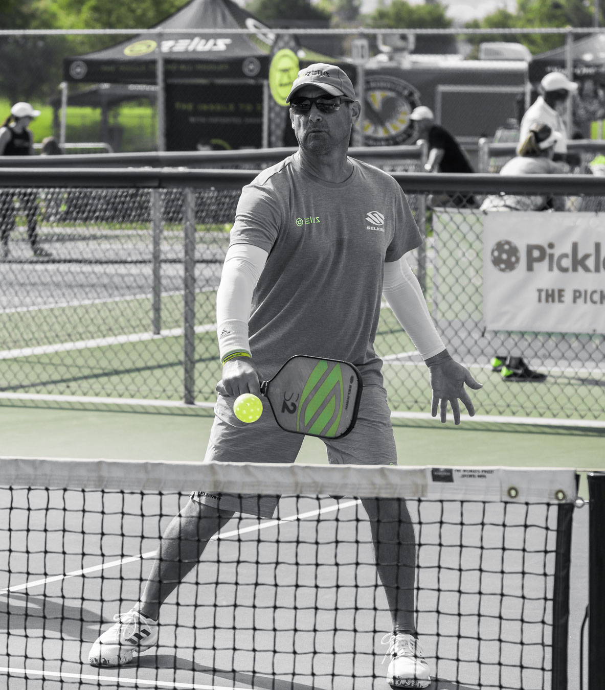 Pickleball player hitting ball