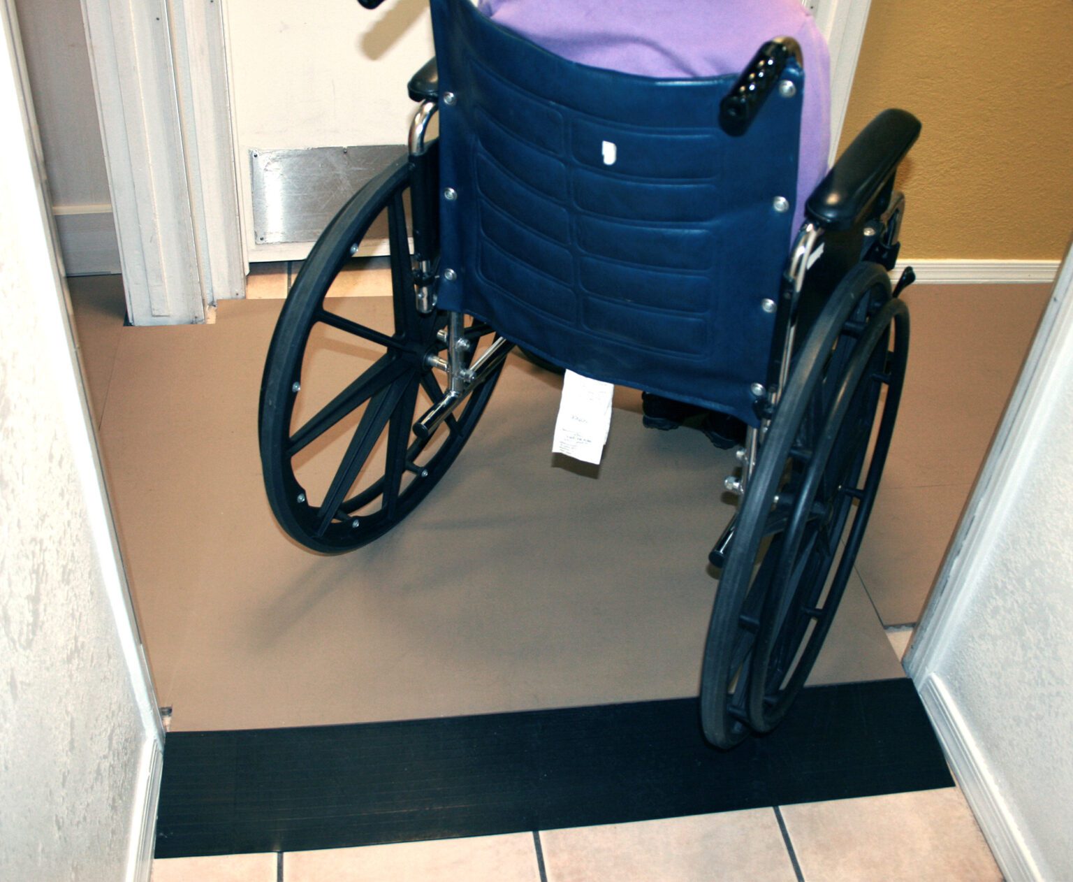 SmartCells Fall Protection - Residential Older worker sitting in manufacturing environment